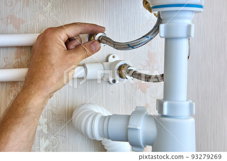 Braided plumbing hoses are used to install faucet in bathroom and connect to home water supply system. 93279269