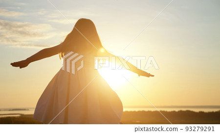 Preschooler girl walks on meadow imagining herself as bird Preschooler girl walks on meadow imagining herself as bird 93279291