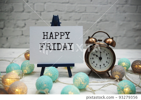 Happy Friday text and alarm clock on white brick wall and wooden background Happy Friday text and alarm clock on white brick wall and wooden background 93279356