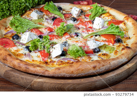 Pizza with bacon and cheese, herbs and cherry tomatoes. With mozzarella, shrimp and octopus, mussels and other products on a wooden background. 93279734
