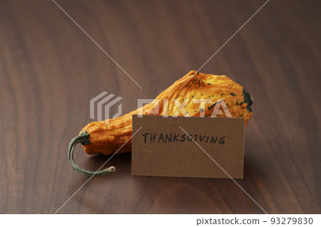Decorative pear pumpkin on wood table with thanksgiving card Decorative pear pumpkin on wood table with thanksgiving card 93279830