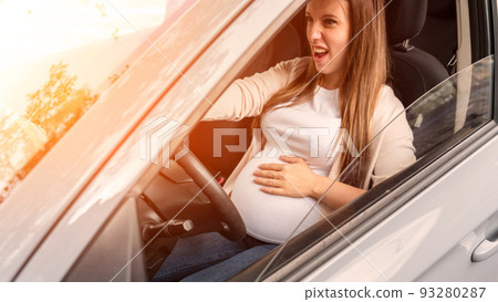 Pregnancy driving car. Young beautiful pregnant woman driving car. Safety pregnancy, mother health care concept. Pregnancy driving car. Young beautiful pregnant woman driving car. Safety pregnancy, mother health care concept. 93280287
