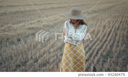 Ukrainian woman in traditional ethnic costume and straw hat in wheat field. Attractive stylish lady Ukrainian woman in traditional ethnic costume and straw hat in wheat field. Attractive stylish lady 93280479