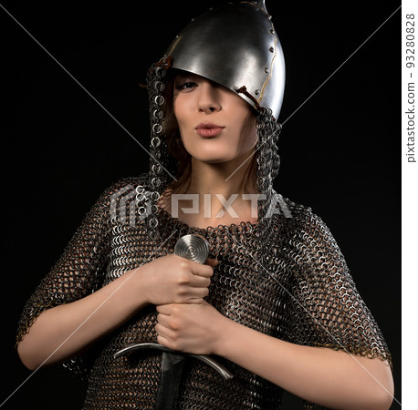 Sexy woman in viking helmet and hauberg with sword Sexy woman in viking helmet and hauberg with sword 93280828