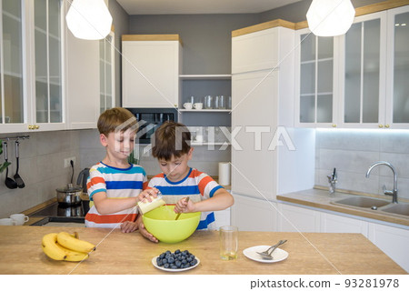 happy family funny kids are preparing the dough, bake cookies in the kitchen 93281978