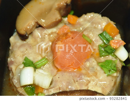 steamed chop pork topping salty egg yolk with mushroom in gravy sauce on bowl  93282841