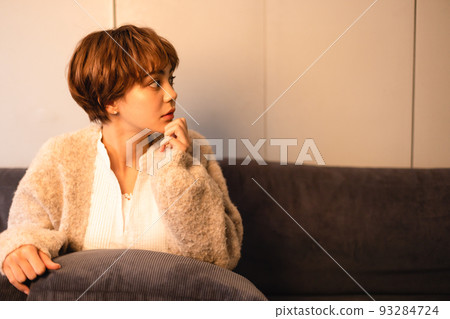 A young lady sitting on the sofa A young lady sitting on the sofa 93284724