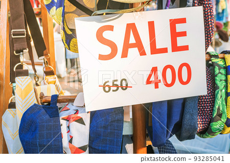 Signs on sale, Discounted clothing department, The outdoor market is reducing clothing prices. Signs on sale, Discounted clothing department, The outdoor market is reducing clothing prices. 93285041