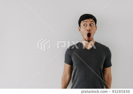 Funny amazing shocked surprised asian man face advertise isolated on white. Funny amazing shocked surprised asian man face advertise isolated on white. 93285830