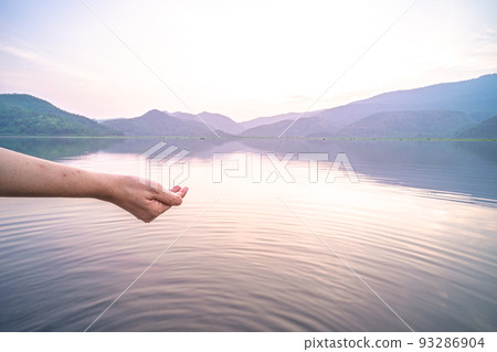 Woman taking clear water by hands Woman taking clear water by hands 93286904