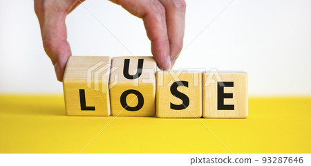 Use or lose symbol. Concept words Use or lose on wooden cubes. Businessman hand. Beautiful yellow table white background. Business Use or lose concept. Copy space. 93287646