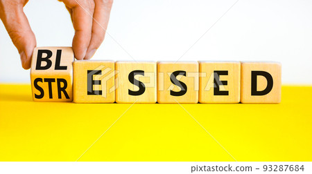 Blessed or stressed symbol. Businessman turns wooden cubes and changes the concept word Stressed to Blessed. Beautiful yellow table white background. Business blessed or stressed concept. Copy space. Blessed or stressed symbol. Businessman turns wooden cubes and changes the concept word Stressed to Blessed. Beautiful yellow table white background. Business blessed or stressed concept. Copy space. 93287684
