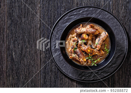 german beef rouladen in thick gravy in bowl 93288872