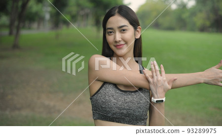 Exercise concept of 4k Resolution. Athletes are stretching muscles in the public garden. arm bending. Exercise concept of 4k Resolution. Athletes are stretching muscles in the public garden. arm bending. 93289975