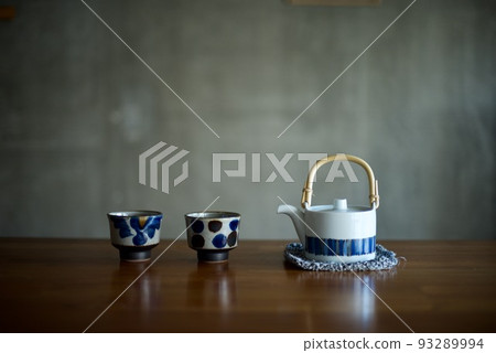 A teapot and teacups on the table A teapot and teacups on the table 93289994
