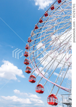 Ferris wheel looking up in the blue sky with clouds 93291701