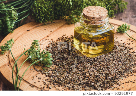 Dill seed oil, organic dill plant flowers and dry seeds, Indian traditional medicinal herb and spice on wooden table Dill seed oil, organic dill plant flowers and dry seeds, Indian traditional medicinal herb and spice on wooden table 93291977