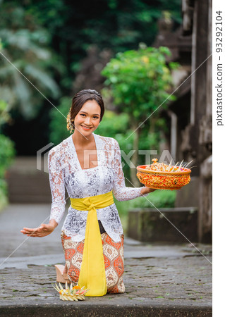 balinese woman in kebaya do prayer and make an offering to go 93292104