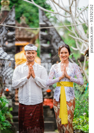 happy balinese couple greeting and smiling gesture at camera happy balinese couple greeting and smiling gesture at camera 93292162