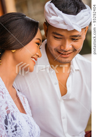 beautiful balinese couple embracing each other and smiling beautiful balinese couple embracing each other and smiling 93292404