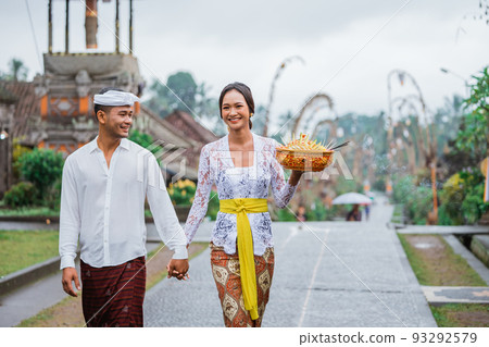 balinese couple walking in pengelipuran village wearing kebaya balinese couple walking in pengelipuran village wearing kebaya 93292579