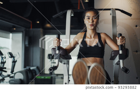 Sporty woman performing abdominal crunches training practicing in gym. 93293882