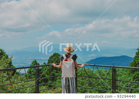 Woman in blue sky and straw hat 93294440
