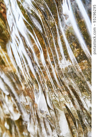 Waves of smooth ice on rock wall in winter 93296295