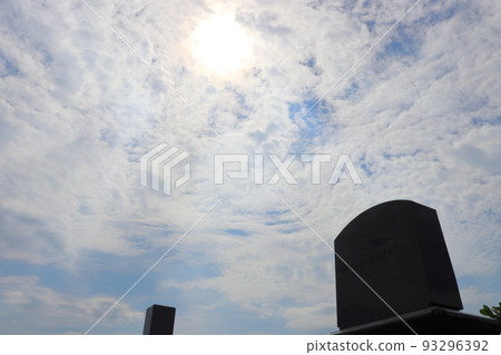 Tomb, cloudy blue sky, sun Tomb, cloudy blue sky, sun 93296392