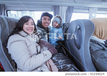 smiling parent and toddler sitting inside the bus 93298024