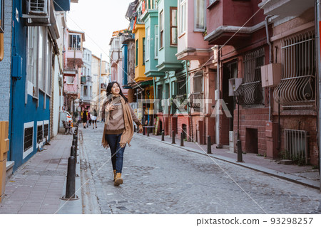 woman walking in balat turkey full of colorful house woman walking in balat turkey full of colorful house 93298257
