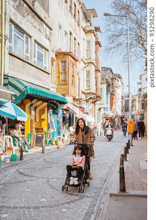 mother push her daughter on stroller while exploring city mother push her daughter on stroller while exploring city 93298290