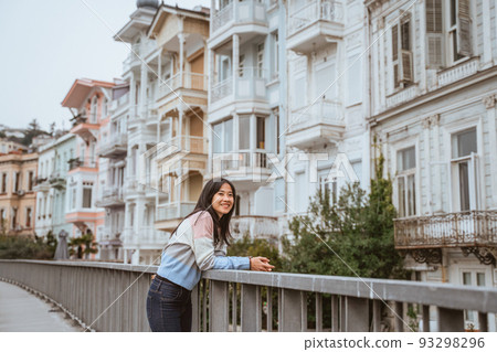 woman enjoying the beauty of building in arnavutkoy woman enjoying the beauty of building in arnavutkoy 93298296