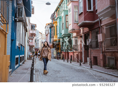 woman walking in balat turkey full of colorful house woman walking in balat turkey full of colorful house 93298327