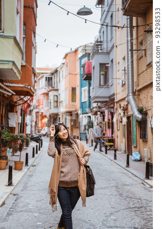 woman walking in balat turkey full of colorful house woman walking in balat turkey full of colorful house 93298533