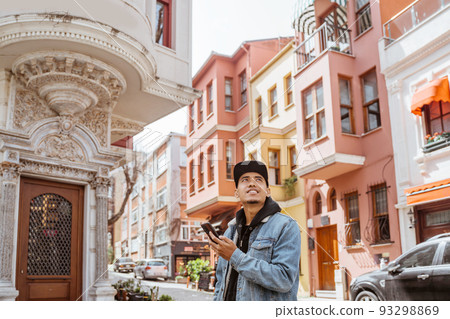 asian male using smart phone while exploring istanbul asian male using smart phone while exploring istanbul 93298869