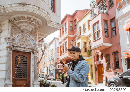 asian male using smart phone while exploring istanbul asian male using smart phone while exploring istanbul 93298891