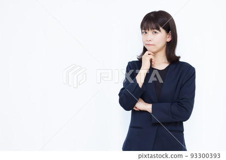 A business woman in her thirties who is seriously worried A business woman in her thirties who is seriously worried 93300393