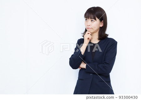 A business woman in her thirties who is seriously worried A business woman in her thirties who is seriously worried 93300430