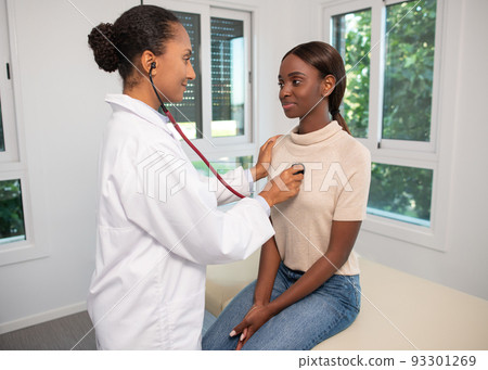 Smiling African American woman at appointment in clinic Smiling African American woman at appointment in clinic 93301269