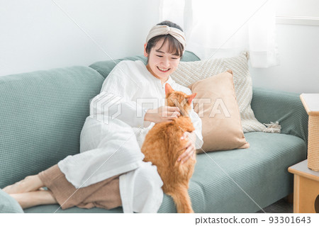 日本女人在沙發上玩寵物貓 93301643