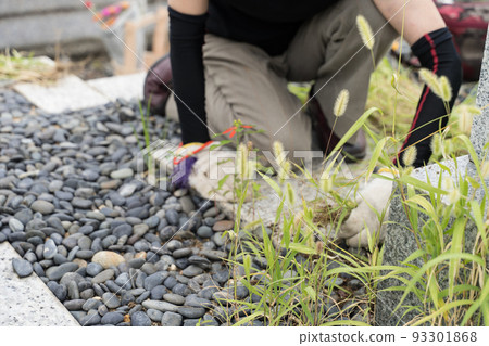 Weeding work on the grave Weeding work on the grave 93301868