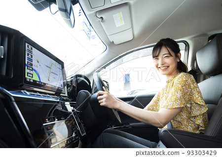 A young woman driving a car A young woman driving a car 93303429