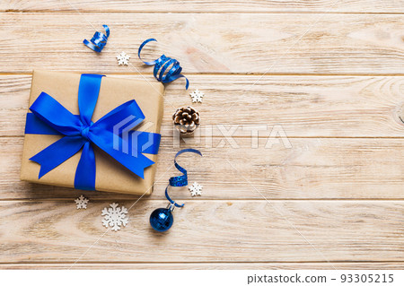 Top view Flat lay Christmas decorations and gift box on colored background with copy space. Christmas or Happy New Year composition Top view Flat lay Christmas decorations and gift box on colored background with copy space. Christmas or Happy New Year composition 93305215