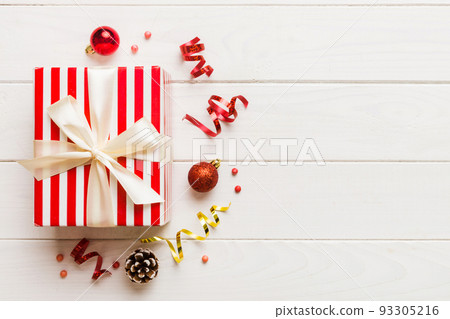 Top view Flat lay Christmas decorations and gift box on colored background with copy space. Christmas or Happy New Year composition Top view Flat lay Christmas decorations and gift box on colored background with copy space. Christmas or Happy New Year composition 93305216