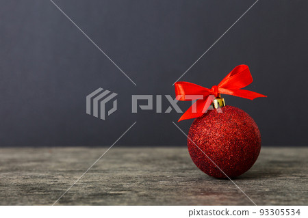 Christmas ball on colored background. decoration bauble with ribbon bow with copy space Christmas ball on colored background. decoration bauble with ribbon bow with copy space 93305534