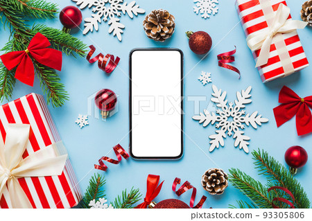 Digital phone mock up with rustic Christmas decorations for app presentation top view with empty space for you design. Christmas online shopping concept. Tablet with copy space on colored background Digital phone mock up with rustic Christmas decorations for app presentation top view with empty space for you design. Christmas online shopping concept. Tablet with copy space on colored background 93305806