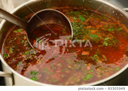 Pot of freshly cooked ukrainian borscht on a kitchen stove. Pot of freshly cooked ukrainian borscht on a kitchen stove. 93305949