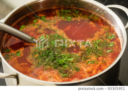 Pot of freshly cooked ukrainian borscht on a kitchen stove. Pot of freshly cooked ukrainian borscht on a kitchen stove. 93305951