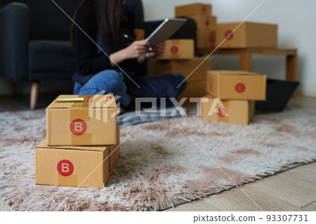 Asian SME business woman working at home office. online shopping concept Asian SME business woman working at home office. online shopping concept 93307731